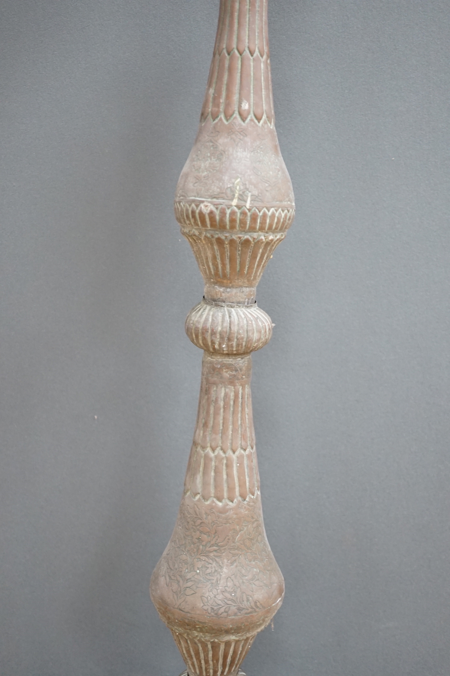 An Islamic copper candle stand, 19th/early 20th century, 97cm high